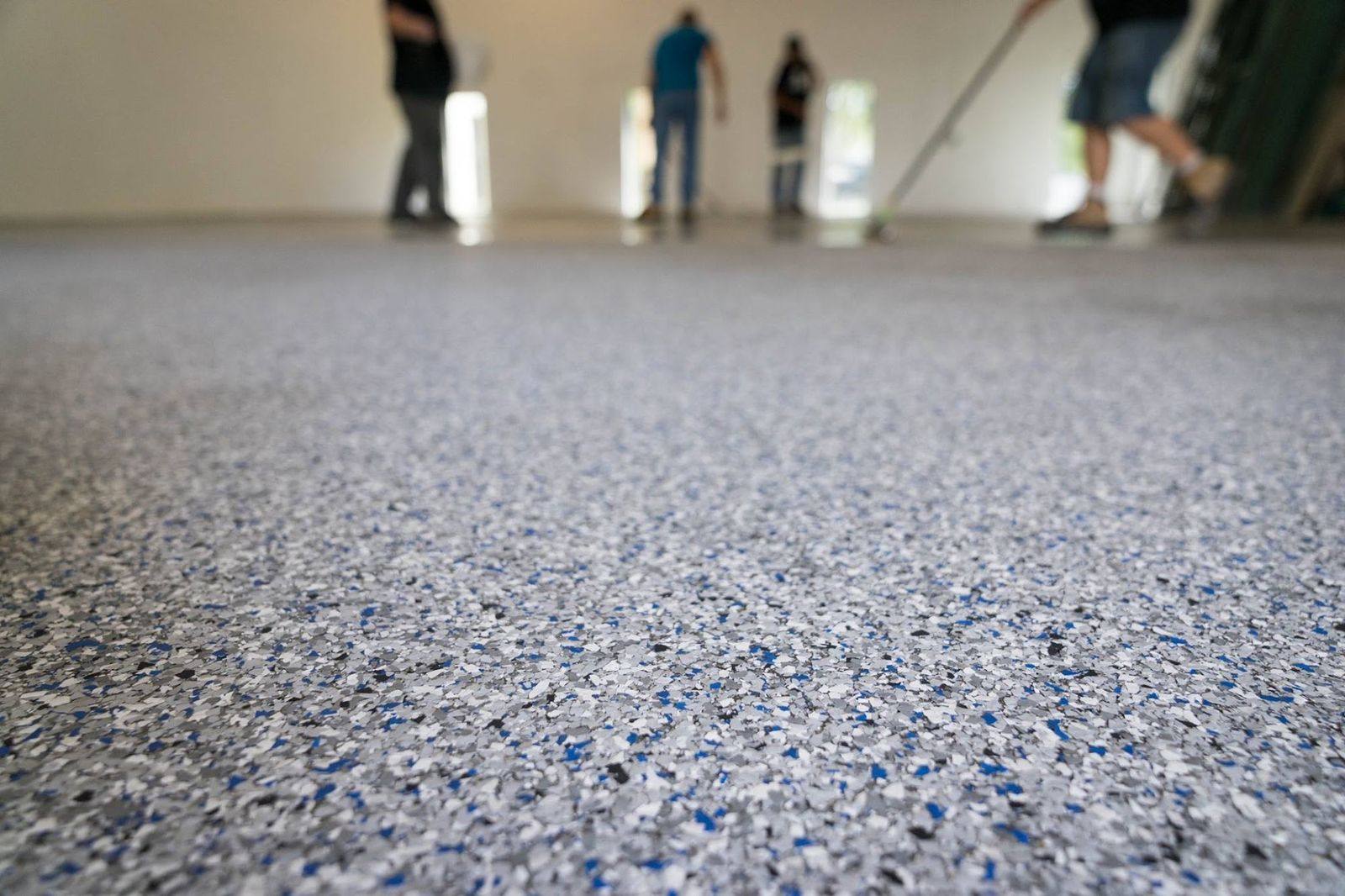 A crew walking a freshly finished flake floor